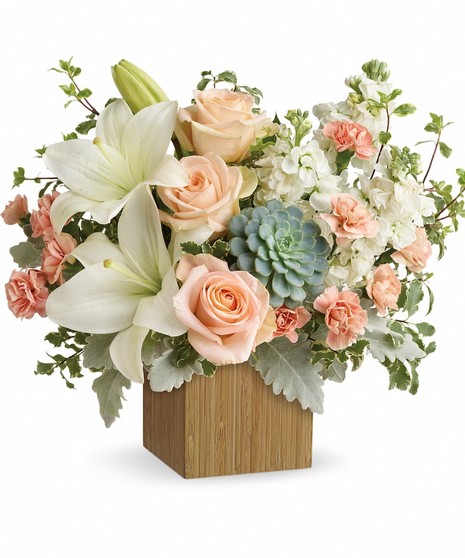 Succulents, peach roses, white asiatic lilies, peach miniature carnations, white stock, along with accent foliage